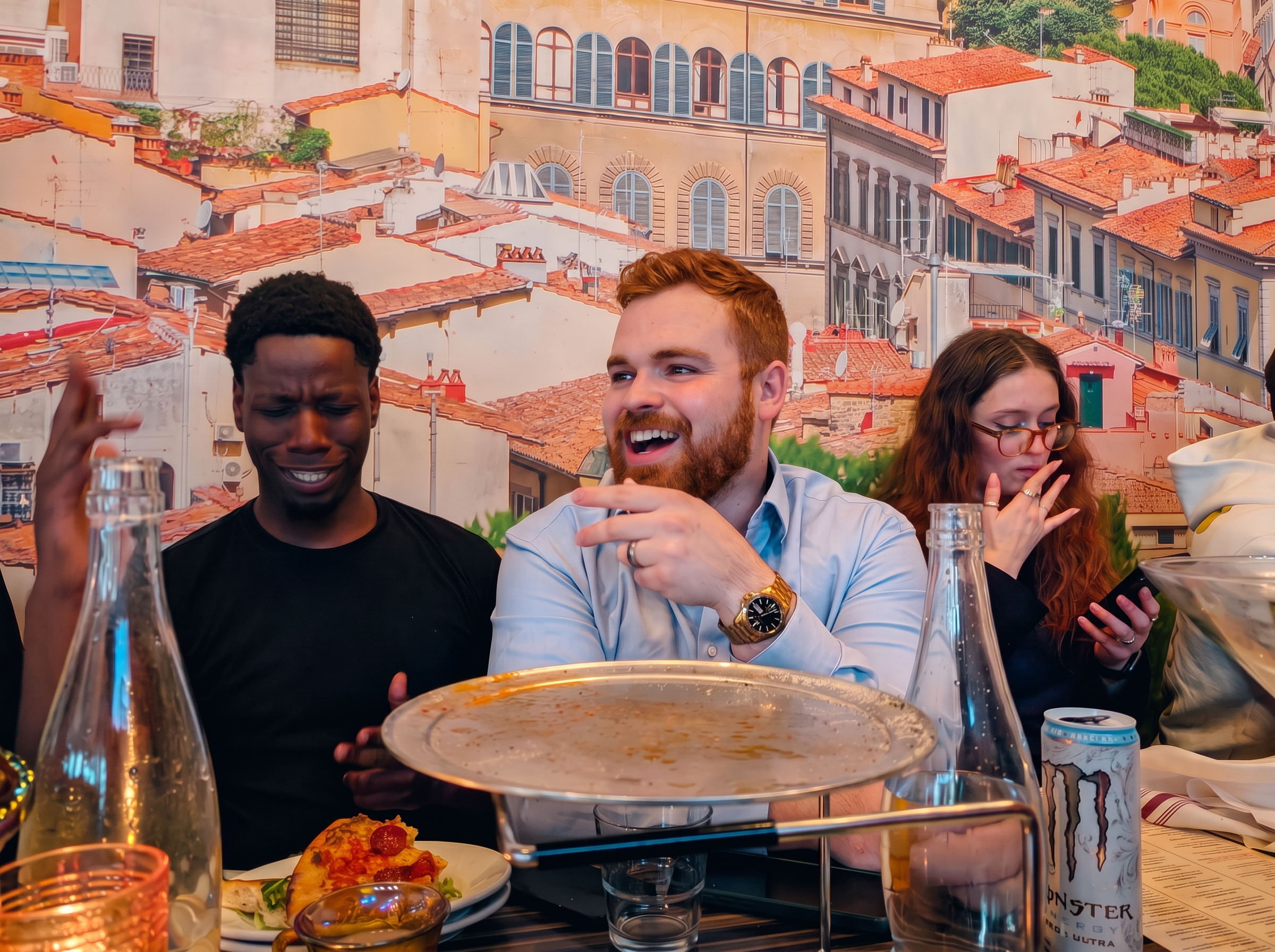 Teammates laughing around a restaurant table